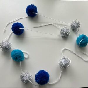 blue, white, and silver pompom and yarn garland